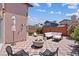 Back patio featuring outdoor seating, a firepit, and a sun umbrella at 1711 Ember Glow Cir, Las Vegas, NV 89119