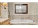 Bright bathroom with a modern soaking tub and marble tile surround at 2000 N Fashion Show Dr # 4015, Las Vegas, NV 89109