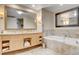 Bright bathroom featuring double sinks, vanity storage, and a soaking tub at 2000 N Fashion Show Dr # 4015, Las Vegas, NV 89109
