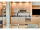 Efficient kitchenette area complete with stainless steel appliances, granite countertops, and microwave at 2000 N Fashion Show Dr # 4015, Las Vegas, NV 89109