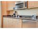 Close-up of kitchenette featuring granite counters, stainless appliances, and ample storage at 2000 N Fashion Show Dr # 4015, Las Vegas, NV 89109