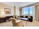 Elegant living room with stylish furniture, a work area, and large windows showcasing breathtaking city views at 2000 N Fashion Show Dr # 4015, Las Vegas, NV 89109