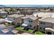 Aerial view of residences, landscaped backyards with patios, in a vibrant community with city views at 2024 Mystic Wave Rd, North Las Vegas, NV 89031