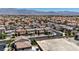 Expansive aerial view of a residential neighborhood with mountains in the background, showcasing community living at 2024 Mystic Wave Rd, North Las Vegas, NV 89031