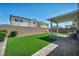 Lush backyard with artificial turf, covered patio, and privacy wall at 2024 Mystic Wave Rd, North Las Vegas, NV 89031