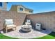 Cozy backyard firepit area with chairs and privacy wall at 2024 Mystic Wave Rd, North Las Vegas, NV 89031