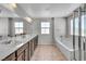 Elegant bathroom with double sinks, a soaking tub, and a glass-enclosed shower at 2024 Mystic Wave Rd, North Las Vegas, NV 89031