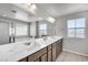 Bright bathroom featuring double sinks, a large mirror, and modern fixtures at 2024 Mystic Wave Rd, North Las Vegas, NV 89031
