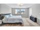 Light-filled bedroom featuring modern decor, plush bedding and neighborhood views at 2024 Mystic Wave Rd, North Las Vegas, NV 89031