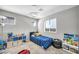 Cozy bedroom with blue accents, carpet flooring, and natural light at 2024 Mystic Wave Rd, North Las Vegas, NV 89031
