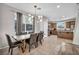 Spacious dining area open to the kitchen, featuring modern light fixture and large window at 2024 Mystic Wave Rd, North Las Vegas, NV 89031