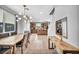 Bright dining area open to kitchen, featuring tile flooring and a contemporary light fixture at 2024 Mystic Wave Rd, North Las Vegas, NV 89031