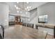 Open dining area with modern chandelier, seamlessly connecting to the kitchen and staircase at 2024 Mystic Wave Rd, North Las Vegas, NV 89031