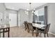 Cozy dining area near the front entryway offers a stylish light fixture and seating for four at 2024 Mystic Wave Rd, North Las Vegas, NV 89031