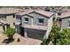 Charming two-story home featuring desert landscaping, a tile roof, and a welcoming two-car garage at 2024 Mystic Wave Rd, North Las Vegas, NV 89031