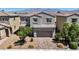 Charming two-story home featuring well-maintained landscaping, a paved driveway, and a welcoming facade at 2024 Mystic Wave Rd, North Las Vegas, NV 89031