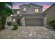 Charming two-story home with a two-car garage and desert landscaping at 2024 Mystic Wave Rd, North Las Vegas, NV 89031