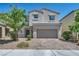 Charming two-story home with a two-car garage, desert landscaping and brick driveway at 2024 Mystic Wave Rd, North Las Vegas, NV 89031