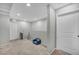 Neutral hallway with carpet, a small chair, and several doors at 2024 Mystic Wave Rd, North Las Vegas, NV 89031
