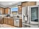 Modern kitchen featuring stainless steel appliances, granite countertops, and wood cabinets at 2024 Mystic Wave Rd, North Las Vegas, NV 89031