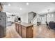 Open-concept kitchen with granite island seamlessly flows into the dining area and living room for easy entertaining at 2024 Mystic Wave Rd, North Las Vegas, NV 89031