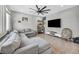 Spacious living room with large sectional sofa, tile floors, TV, and shelving at 2024 Mystic Wave Rd, North Las Vegas, NV 89031