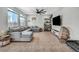 Bright living room boasts a comfortable sectional sofa and large windows, ideal for relaxation and entertaining at 2024 Mystic Wave Rd, North Las Vegas, NV 89031