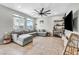 Inviting living room with a large sectional sofa, tile floors, and stylish decor for comfortable living at 2024 Mystic Wave Rd, North Las Vegas, NV 89031