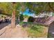 Picturesque backyard with trees, grass, and a covered patio area at 2229 Armacost Dr, Henderson, NV 89074