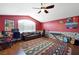 Spacious bedroom with vaulted ceiling, laminate floors, large window, and custom paint at 2229 Armacost Dr, Henderson, NV 89074