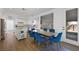 Bright dining area featuring an island, wood floors, white cabinets, and blue velvet chairs at 2229 Armacost Dr, Henderson, NV 89074