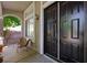 Inviting entryway featuring a stylish black door, a cozy sitting area, and plenty of natural light at 2229 Armacost Dr, Henderson, NV 89074