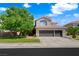 Inviting two-story home with a well-maintained lawn, mature landscaping, and a spacious three-car garage at 2229 Armacost Dr, Henderson, NV 89074