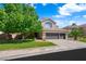 Charming two-story home with a three-car garage and well-maintained front lawn and mature shade trees at 2229 Armacost Dr, Henderson, NV 89074