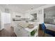 Modern kitchen with white cabinets, granite countertops, a spacious island, and stainless steel appliances at 2229 Armacost Dr, Henderson, NV 89074