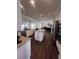 Spacious kitchen featuring an island, granite countertops and stainless steel appliances overlooking the living area at 2229 Armacost Dr, Henderson, NV 89074