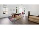 Open-concept living area with a pool table, large windows, and hardwood floors at 2229 Armacost Dr, Henderson, NV 89074