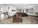 Spacious living room featuring hardwood floors, a ceiling fan, and a brown sectional sofa at 2229 Armacost Dr, Henderson, NV 89074