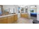 Spacious main bathroom with double sinks, granite counters, and a separate entrance to the main bedroom at 2229 Armacost Dr, Henderson, NV 89074