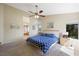 Main bedroom featuring a ceiling fan, a large window, and a glimpse into the bathroom at 2229 Armacost Dr, Henderson, NV 89074