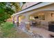 Well-designed covered patio featuring stone columns, comfortable seating, and an outdoor kitchen area at 2229 Armacost Dr, Henderson, NV 89074