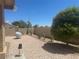 The backyard offers easy maintenance with a gravel groundcover and desert plantings at 2406 Pebble Springs Ct, Henderson, NV 89074