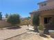 The backyard features desert landscaping, offering a private outdoor space, and a covered patio at 2406 Pebble Springs Ct, Henderson, NV 89074