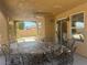 Welcoming covered patio with tile flooring, a ceiling fan, and patio seating, perfect for outdoor dining at 2406 Pebble Springs Ct, Henderson, NV 89074