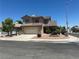 Inviting two-story home with a two-car garage, desert landscaping, and a well-maintained lawn at 2406 Pebble Springs Ct, Henderson, NV 89074
