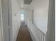 Upstairs hallway features neutral carpet, white walls, and white railing at 2406 Pebble Springs Ct, Henderson, NV 89074