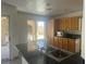 Open kitchen with laminate countertops, ample cabinetry, a stainless steel sink, and access to the backyard at 2406 Pebble Springs Ct, Henderson, NV 89074
