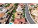 Aerial view showcases a home's putting green, pool, covered patio, solar panels, and desert landscaping at 2605 Orchid Valley Dr, Las Vegas, NV 89134