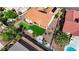 Aerial view showcases a home with a terracotta tile roof, putting green, and professional desert landscaping at 2605 Orchid Valley Dr, Las Vegas, NV 89134