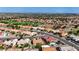 Areal view of the home and neighborhood, showcasing the golf course in the distance at 2605 Orchid Valley Dr, Las Vegas, NV 89134